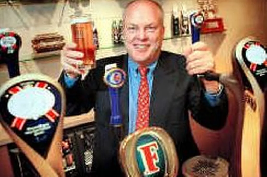 S&N chief executive Tony Froggatt behind the bar. Photo: Manchester Evening News