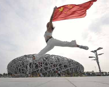 Bird's Nest National Stadium in Beijing, China, with Olympics dancer. Photo: China Daily.