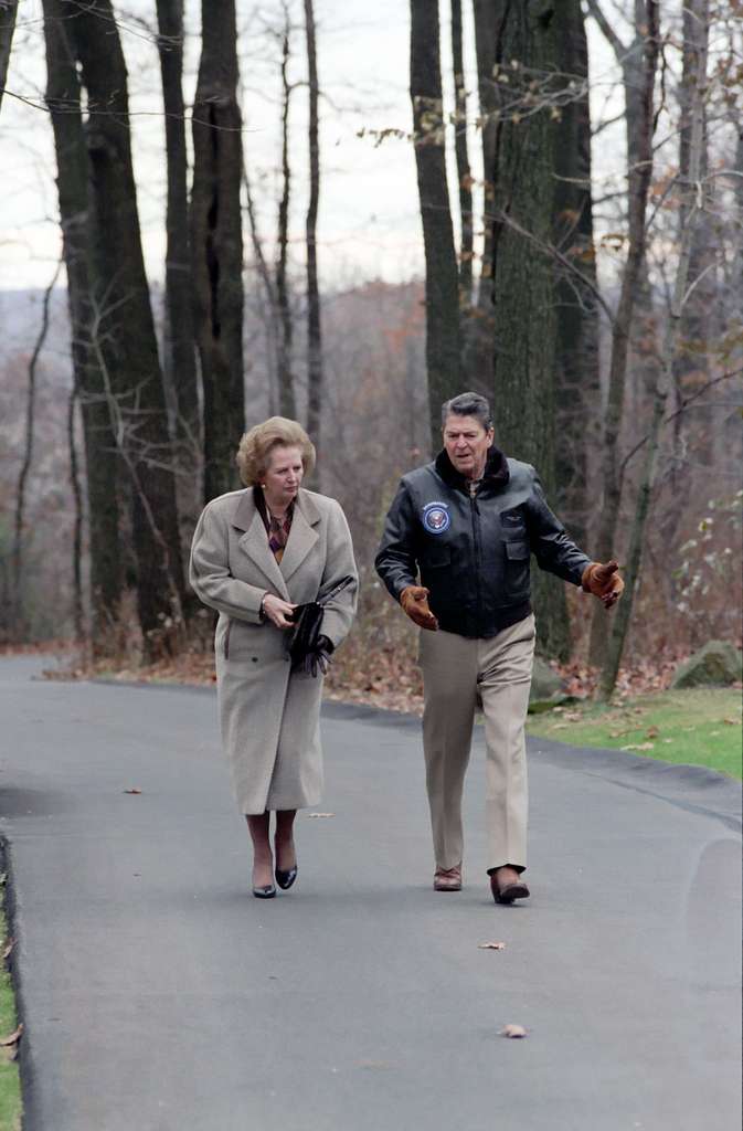 Talking Reaganomics? Prime minister Margaret Thatcher walks with president Ronald Reagan at Camp David, Maryland, on 15 Nov 1986. Public domaine image.