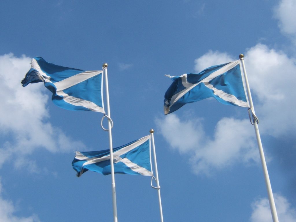 Scottish flags at the English border. Photo: Barbara Carr / Three Saltires at the Border / CC BY-SA 2.0