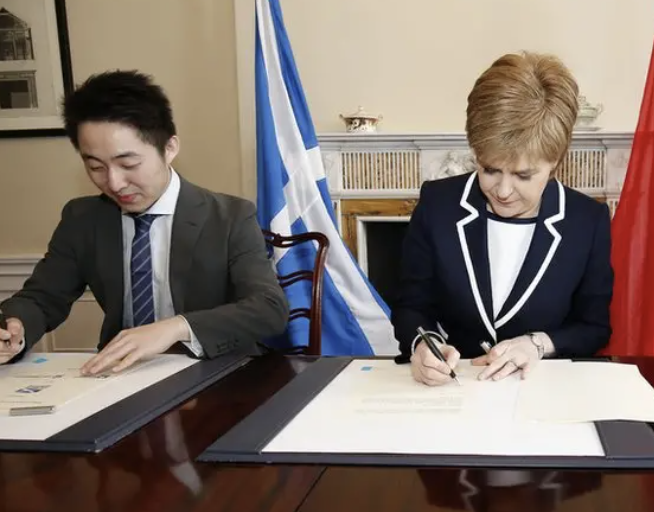 Nicola Sturgeon signs a deal with Sinofortone Group's Yu “Peter” Zhang and China Railway No. 3 Engineering Group in Bute House on 21 March 2022