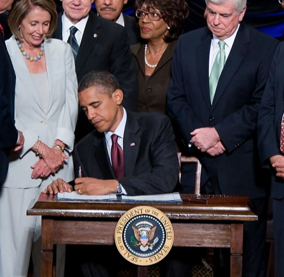 President Barack Obama signs the Dodd-Frank Act in Washington on 21 July 2010. (Official photo: Lawrence Jackson).